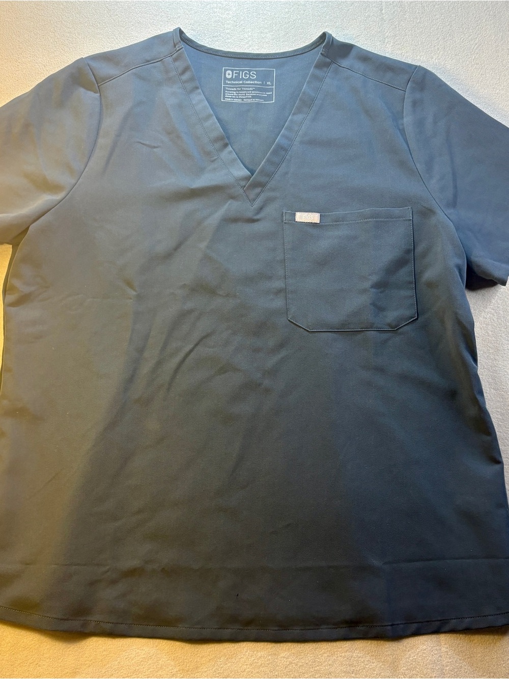 Figs Scrub Top with Gold Logo Tab on Charcoal Fabric